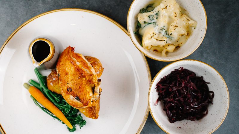 roast chicken with cauliflower cheese, roast potatoes and red cabbage.