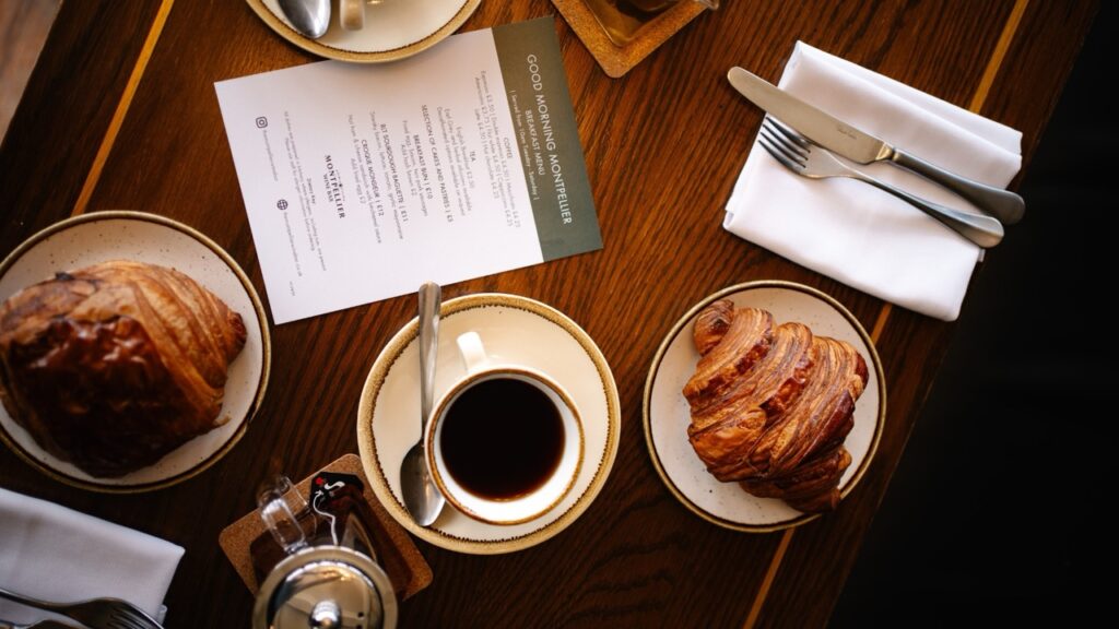 Croissant and pain au chocolat on a table with coffee and tea for breakfast and brunch at the montpellier wine bar.