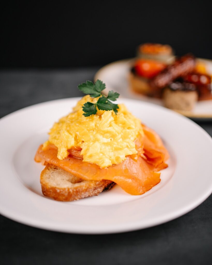 Smolked salmon with scrambled eggs on a sourdough toast served at the montpellier wine bar breakfast menu
